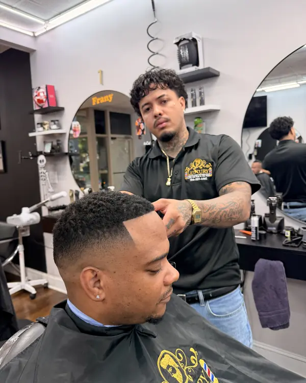 Barber lining up a client's haircut